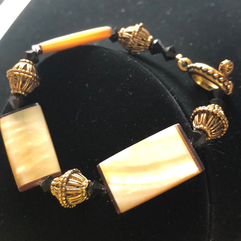Creamy ivory, black and bronze bead bracelet.